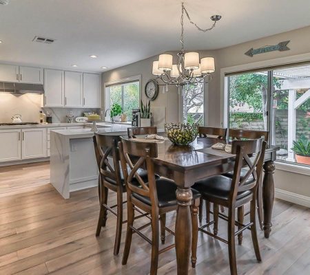 A kitchen featuring a dining table surrounded by chairs, creating a cozy eating area.
