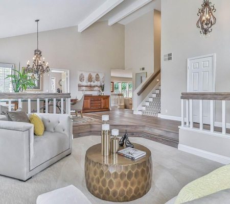 A cozy living room featuring a staircase and a comfortable couch, creating an inviting atmosphere.
