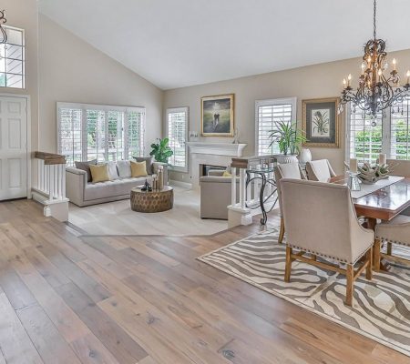 A spacious living room featuring hardwood floors and a striking zebra rug.