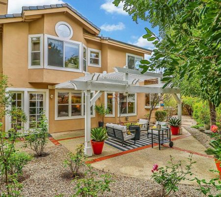 A home featuring a patio and a covered patio, showcasing outdoor living space and architectural design.